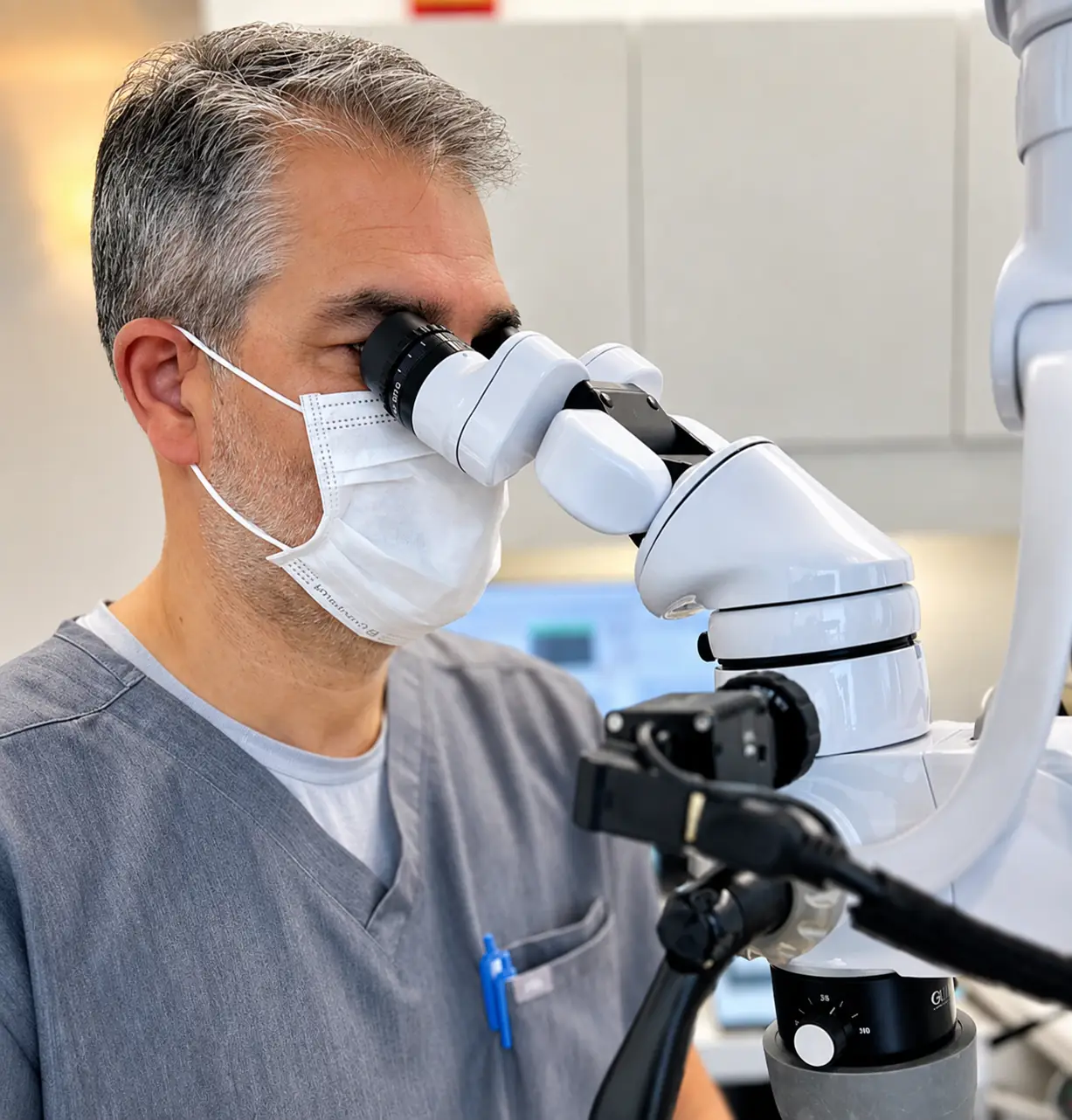 Dentist examining a patient through a precision microscope